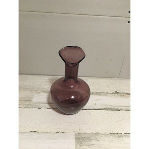 Beautiful amethyst colored glass vase with swirl gear shaped opening.